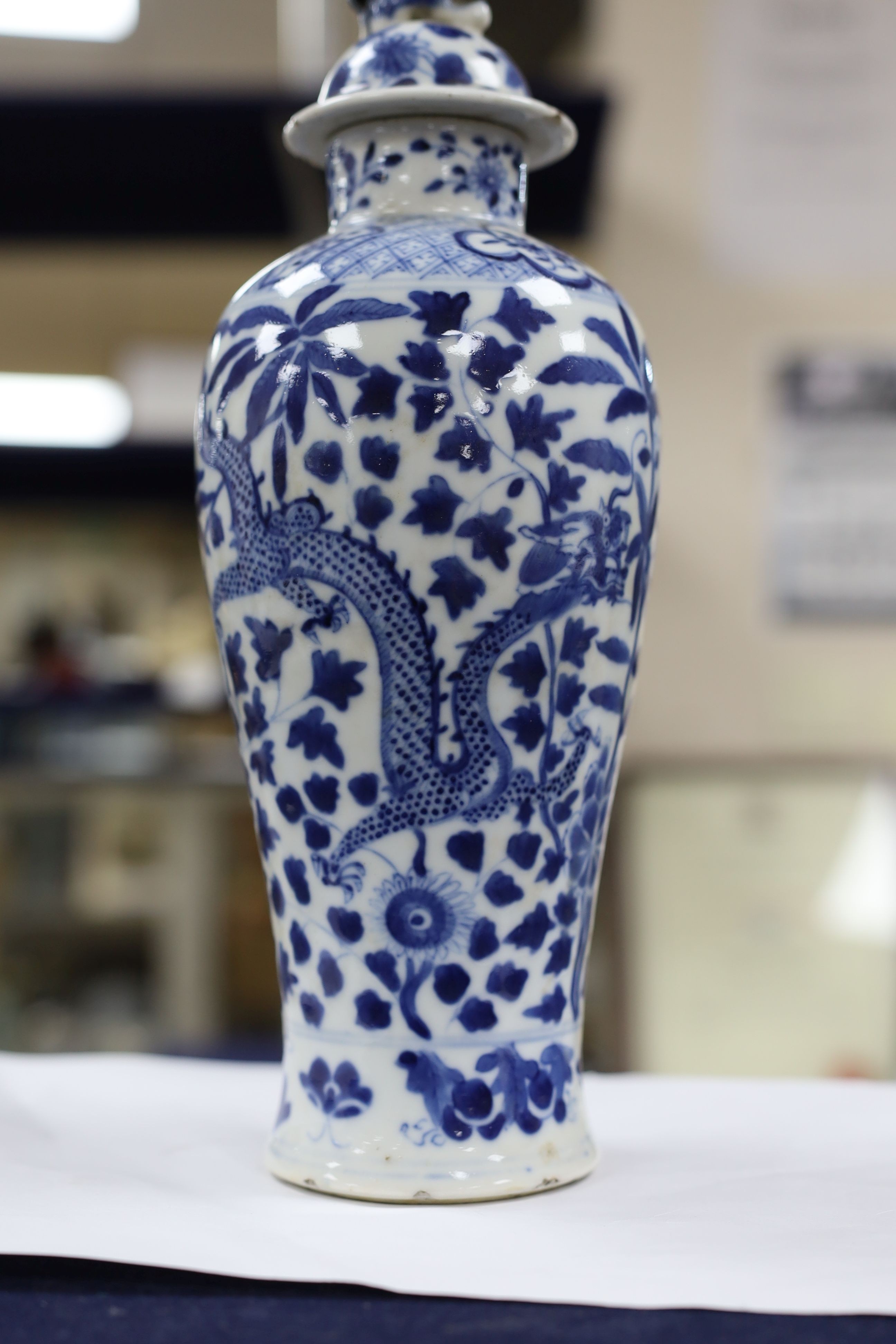 A pair of Chinese blue and white dragon vases and covers, circa 1900. 28cm